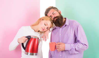 Starting day together. Prepare drink in minutes. Electric kettle boils water quickly. Modern technology make life easier. Save time modern technology. Couple prepare morning drink electric kettle
