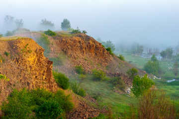 Two sunlight rocky cliffs and misty forest. Sunrise landscape. Russia, Rostov-on-Don region