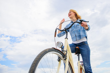 Latest news for recreational and leisure cyclists. Girl rides bike sky background. Emotional woman...