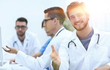 Handsome mature male doctor smiling to the camera