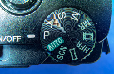 Detail view of the menu selector wheel on a small black compact camera