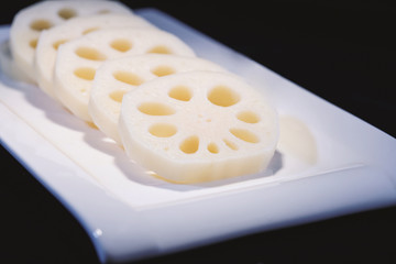 Closeup lotus roots sliced on the white plate
