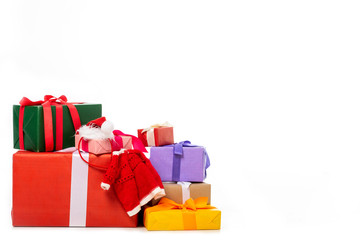 christmas hat and vest on pile of gift boxes isolated on white background