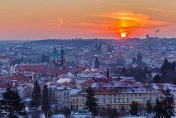 Fototapeten Winter morning in Prague, Czech Republic. Prague roofs covered snow during sunrise. © vitaprague