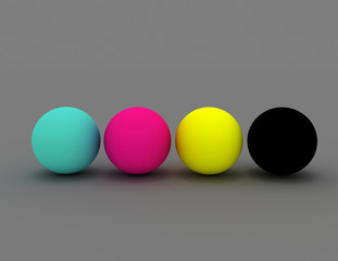 3d render of four spheres in CMYK colours