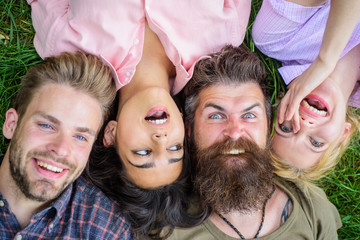 Blonde or brutal hipster friends same wave. Different but still best friends. Friendship through whole life. Youth men and women head to head. Company friends lay grass top view. Diversity concept