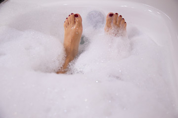Woman taking a bath of foam