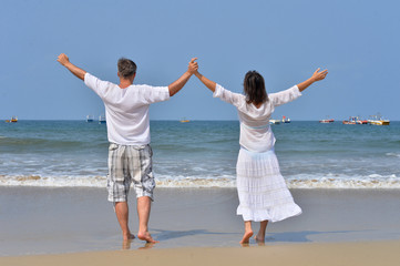 Portrait of a couple with raised hands