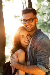 wonderful young couple hug and enjoy life together with natural outdoor laisure activity lifestyle during the summer and the sunset in backlight. 