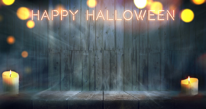 Misty Happy Halloween room. Night wooden table and wall backgroundwith neon caption.