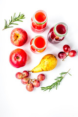 plastic bottles with fruit drinks on white background top view