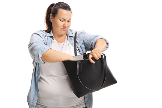 Overweight Female Searching For Something In Her Handbag