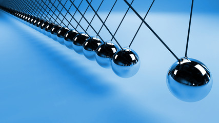 Newton's cradle, action and reaction concept, metal balls in motion 