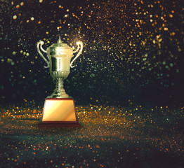 silver trophy on abstract gold glitter background..