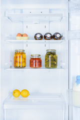 lemons, preserved vegetables and eggs in fridge