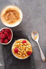 Bowl of granola with yogurt and fresh berries on black background from top view. Healthy breakfast. Copy space.