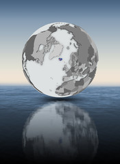 Iceland on globe above water