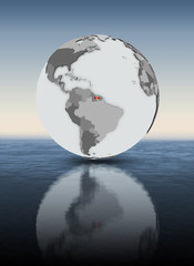 Fototapeta premium Suriname on globe above water