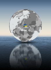 Fototapeta premium Ukraine on globe above water
