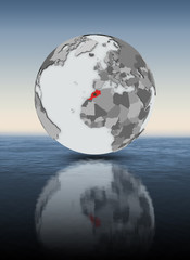 Morocco on globe above water