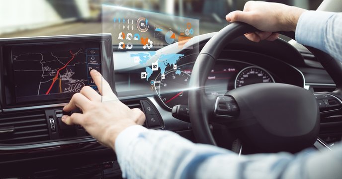 Man driving in car with heads up display interface