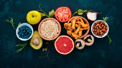 Food. Vegetables, fruits, nuts and berries. Healthy food. On the stone table. Top view. Free space for text.