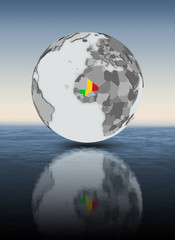 Mali on globe above water