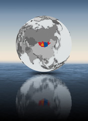Mongolia on globe above water