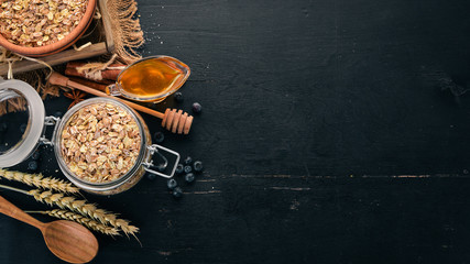 Dry oatmeal porridge in a plate. Breakfast. On a wooden background. Top view. Free space for text.