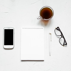 Office supplies flat lay on white. Square