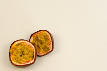 Passion fruit in half on a green background with copy space 