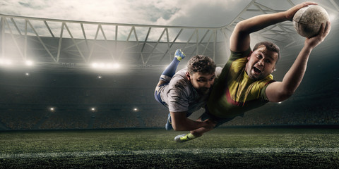 Two male Rugby players fight for the ball in flight on professional rugby stadium - obrazy, fototapety, plakaty