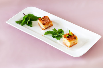 Two piecies Basbousa or Namoora traditional arabic dessert.