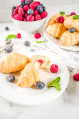 Home baked croissants with raspberries, and blueberries
