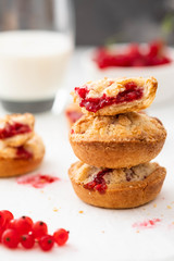 Christmas cookies. Linzer cookies with raspberry jam on green table background. Traditional Austrian biscuits filled. Top view and copy space