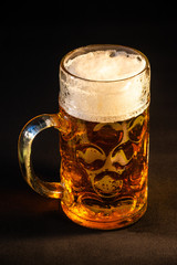 Traditional Octoberfest Bavarian beer in a big one liter mug with wet walls, Germany