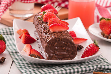 Chocolate roll with strawberries.