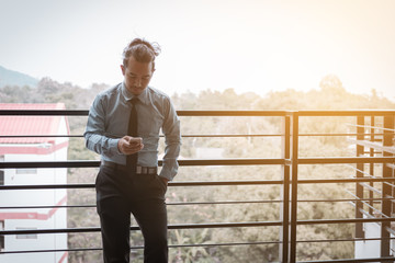 Young asian businessman talking on phone and happiness for work.