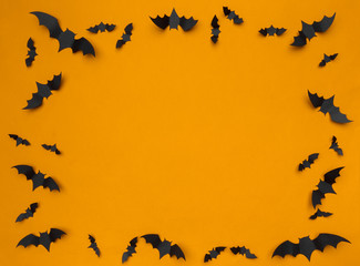 halloween and decoration concept - paper bats flying