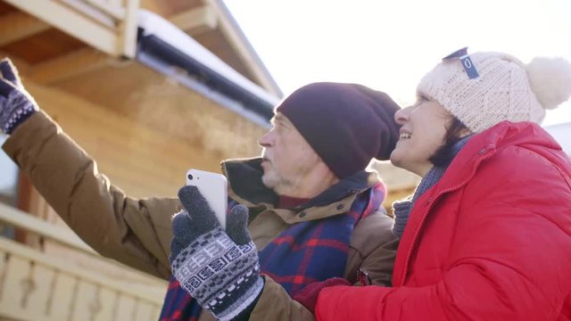 Mature couple using mobile phone