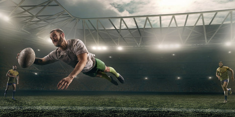 Dirty rugby player catch the ball in flight on professional rugby stadium