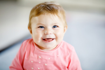 Portrait of cute baby girl at home. Little girl looking at the camera and smiling. Family, new life, childhood, beginning concept