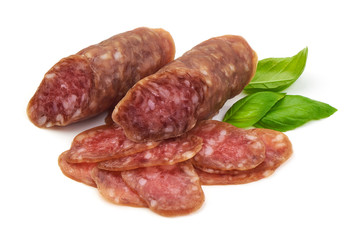 Smoked sausage with thin slices and green basil leaves, isolated on white background