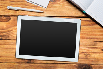 White digital tablet on wooden table