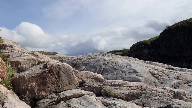 Clouds over the rocks, mountain landscape. Averoy, Norway. Low-angle shot,
