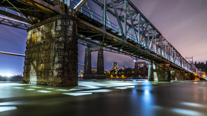 Patullo Bridge, Surrey, British Columbia, Canada. Long exposure of the bridge over the water. Sky Train Bridge.