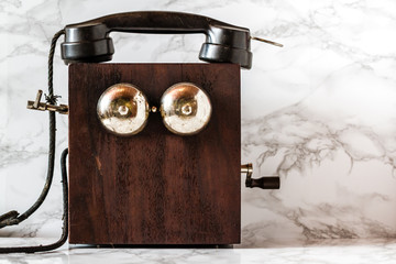 Antique Magneto Hand Crank Telephone Set on Marble Background