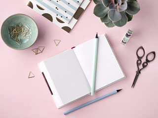 Composed creative workplace with notepad and supplies.