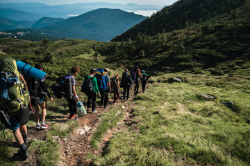 Fototapeta premium Group of hikers walking on a mountain. Carpathains, Ukraine