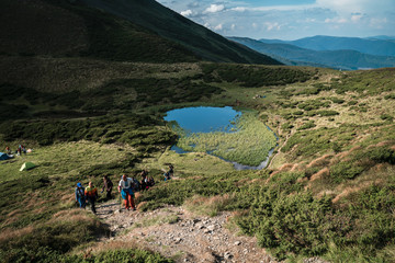 Group of hikers walking on a mountain. Carpathains, Ukraine